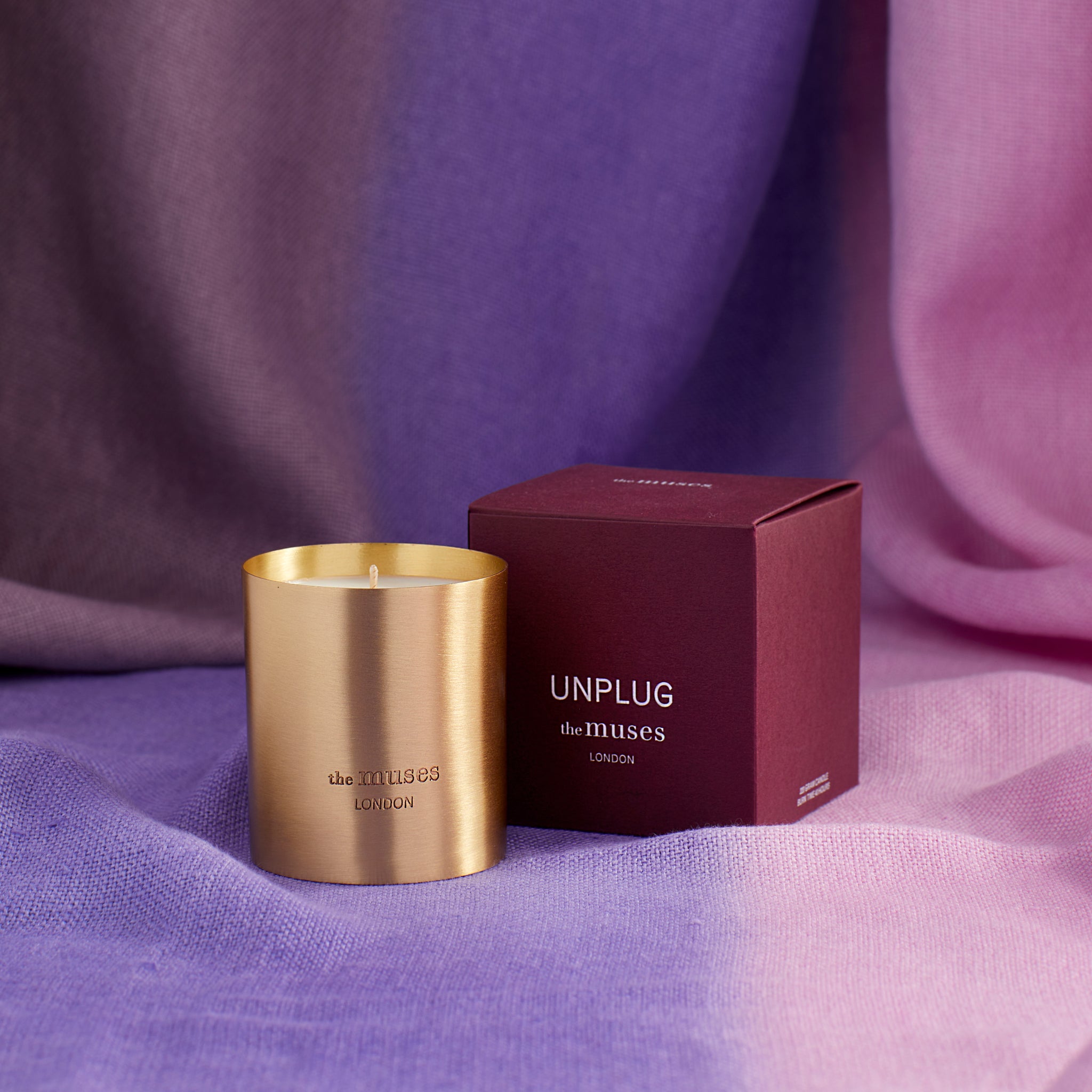 Unplug scented 100% natural wax candle 220g next to claret red candle box. Front
