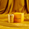 Supercharge scented100% natural wax candle 220g in pure brass container next to bright yellow candle box with closed lid. Front.