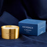 Kickback scented 100% natural wax candle 110g in pure brass container next to blue candle box with closed lid. Front