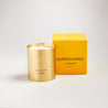 Supercharge scented100% natural wax candle 220g in pure brass container next to bright yellow candle box with closed lid. Front.